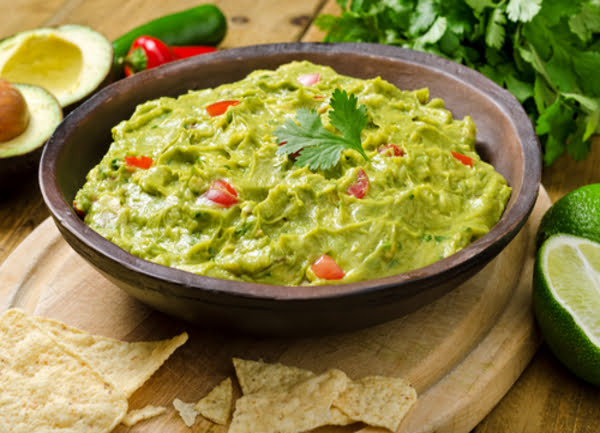 Preparación tradicional de guacamole pisado en crema homogénea para servir